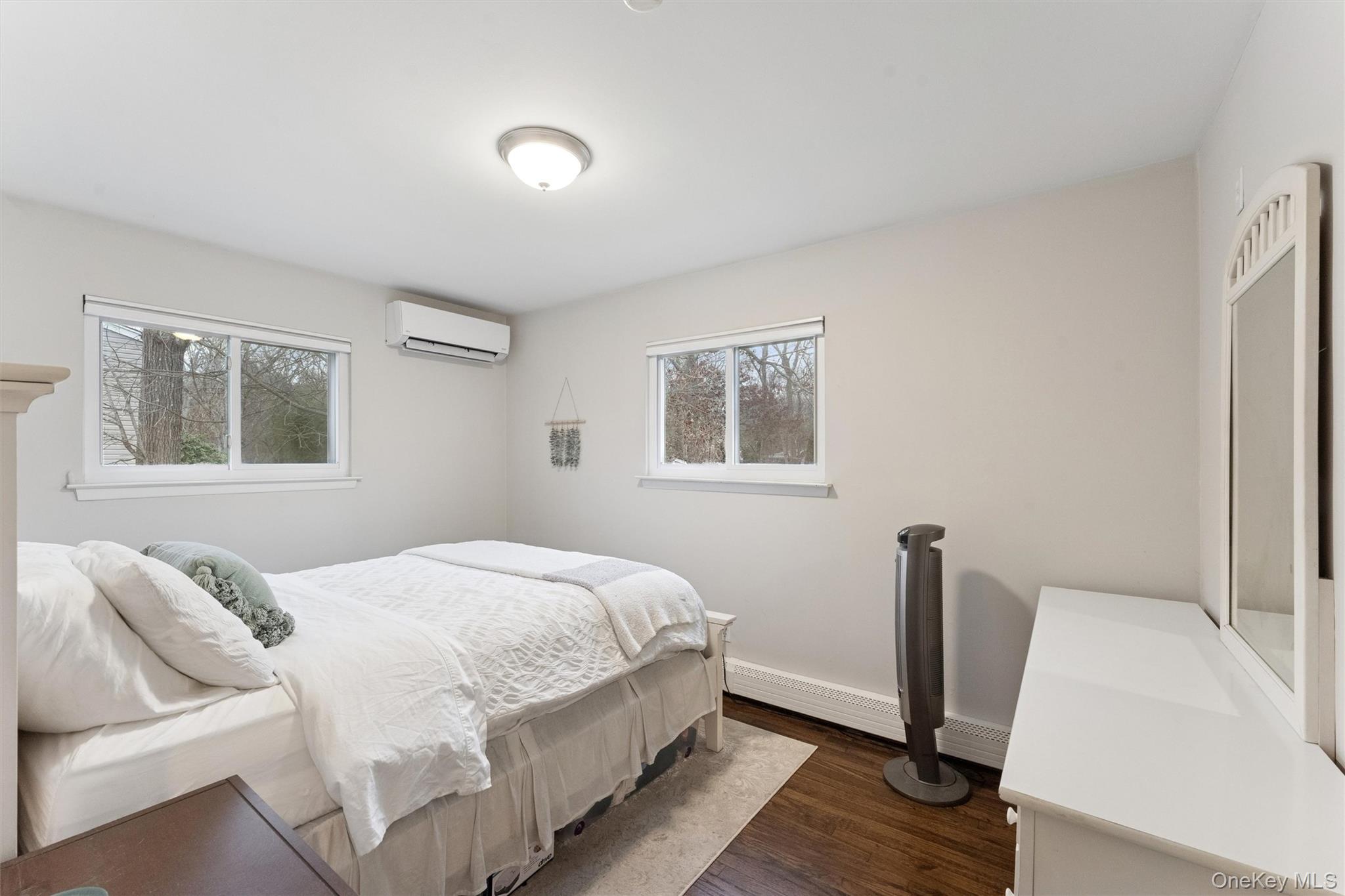 31 Howell Place Speonk, NY 11972 - Photo 13 of 16 Bedroom featuring dark wood-style floors and a wall mounted air conditioner