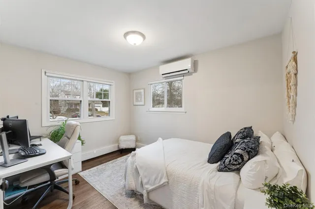 a bedroom with a bed window and table