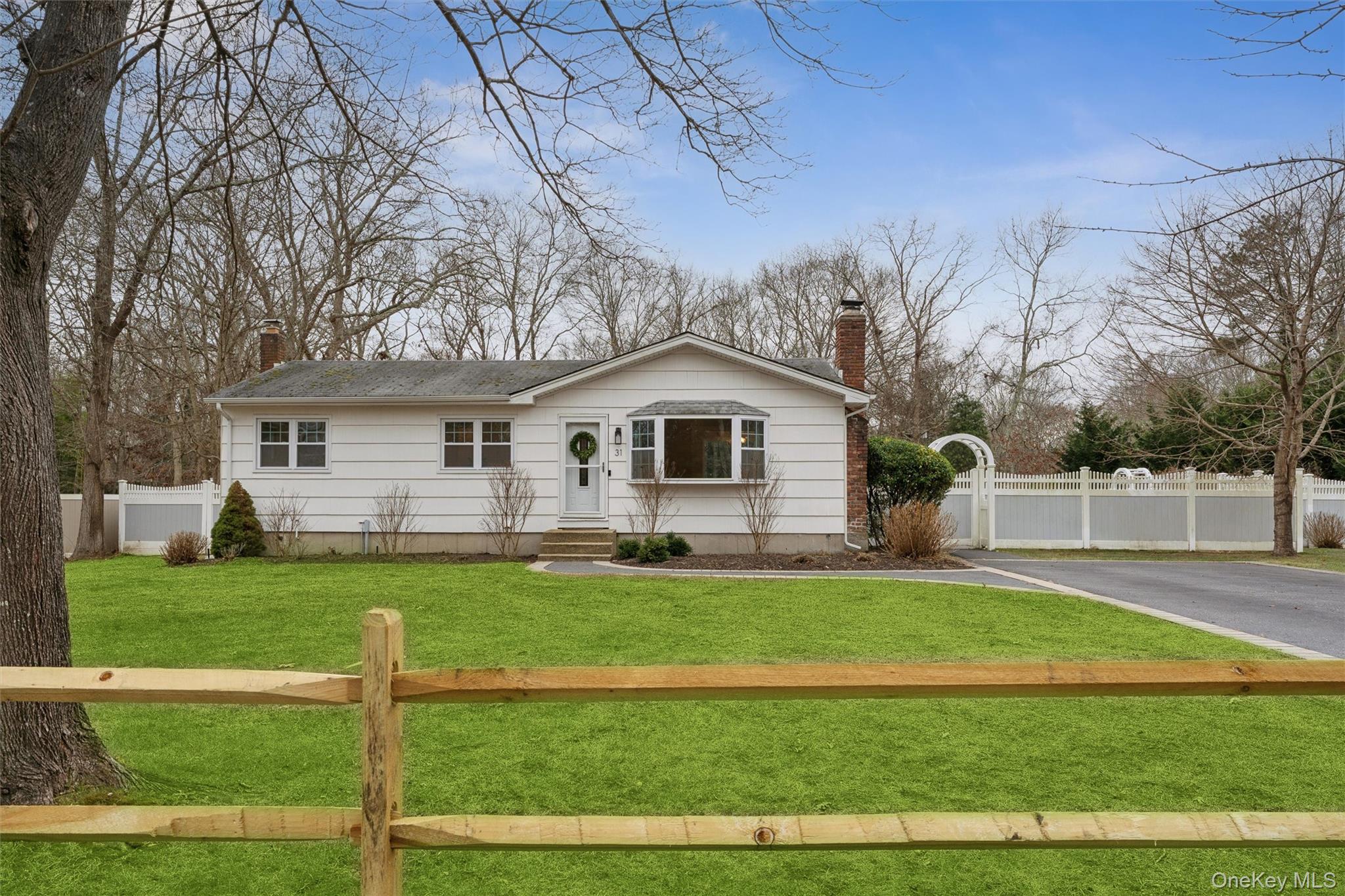 31 Howell Place Speonk, NY 11972 - Photo 3 of 16 View of front facade featuring a chimney