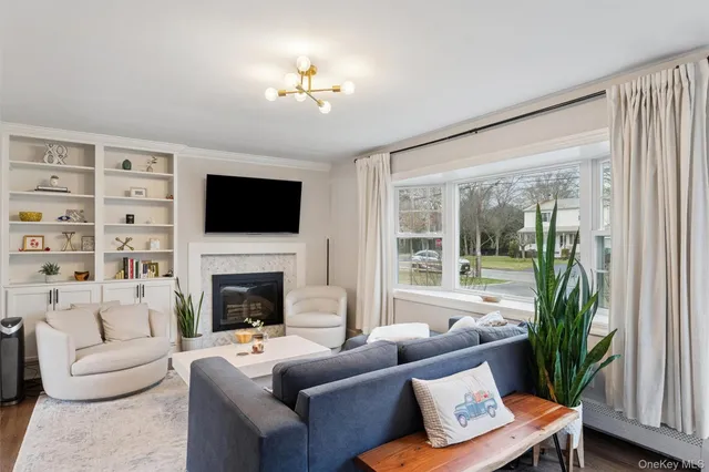 a living room with furniture a fireplace and a flat screen tv
