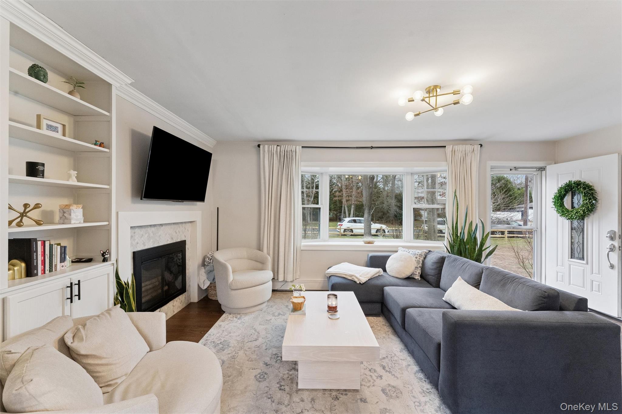 31 Howell Place Speonk, NY 11972 - Photo 9 of 16 Living room featuring a premium fireplace, wood finished floors, and built in shelves