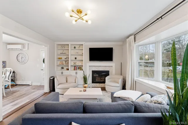 a living room with furniture a fireplace and a flat screen tv