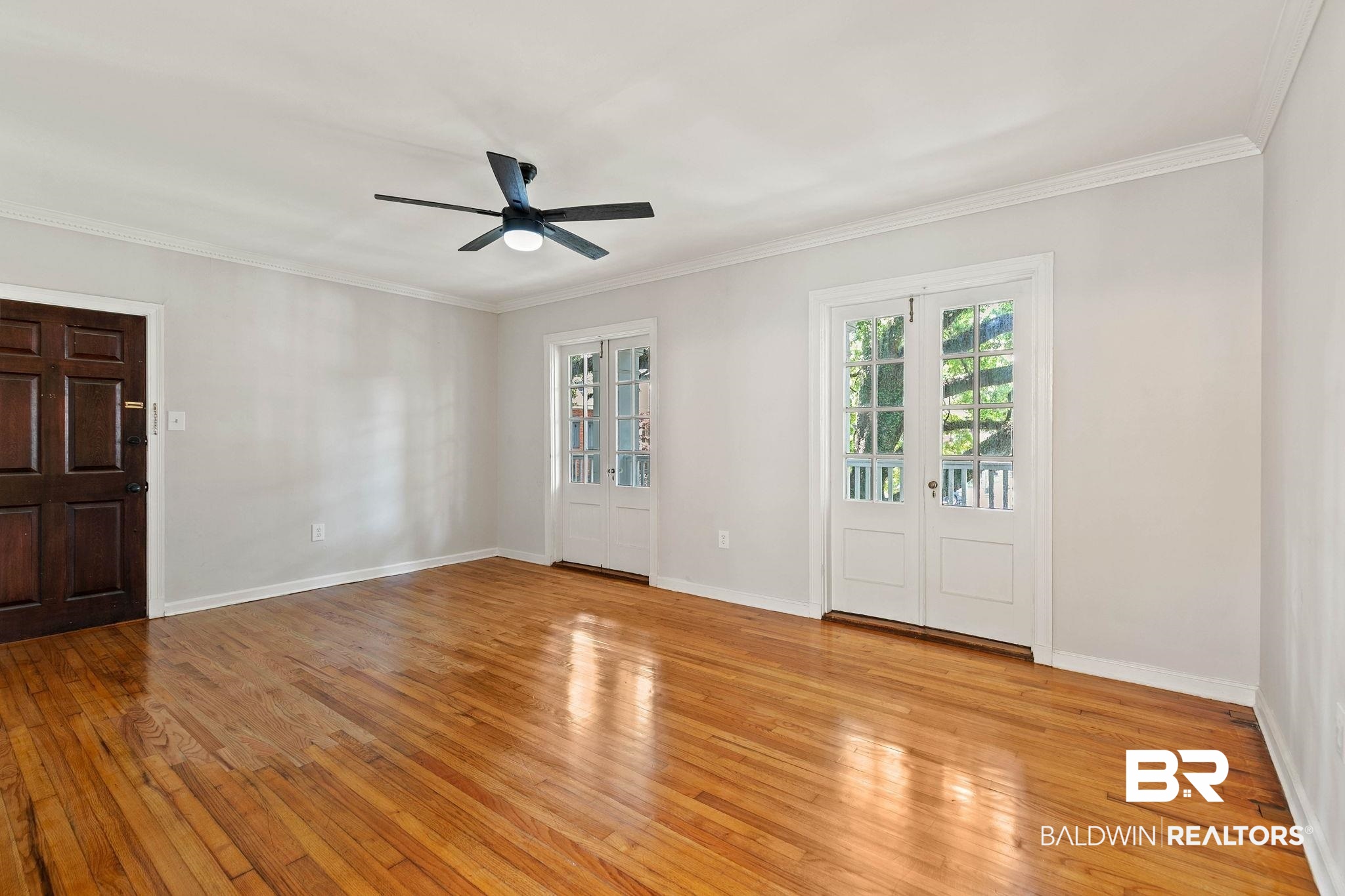 214 Upham Street, Unit 8D Mobile, AL 36607 - Photo 5 of 36 Entrance foyer with light wood-style floors, ornamental molding, a ceiling fan, and french doors