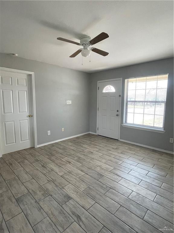 2306 Ocaso Road Mission, TX 78572 - Photo 4 of 12 wooden floor in an empty room with a window