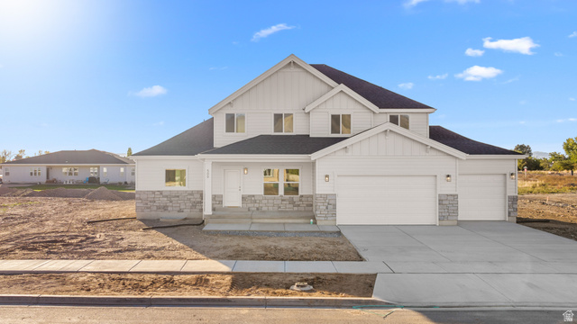 1510 West 600 North, Unit 4A Mapleton, UT 84664 - Photo 1 of 23 Modern farmhouse with covered porch, board and batten siding, stone siding, a shingled roof, and concrete driveway