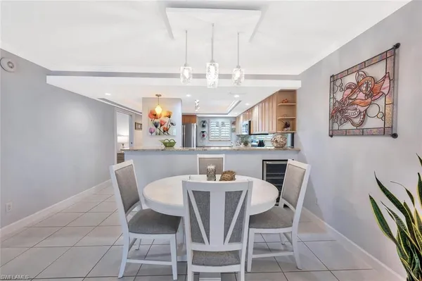 a view of a dining room with furniture and a chandelier
