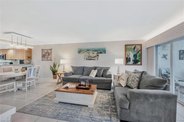 a living room with furniture potted plant and a window