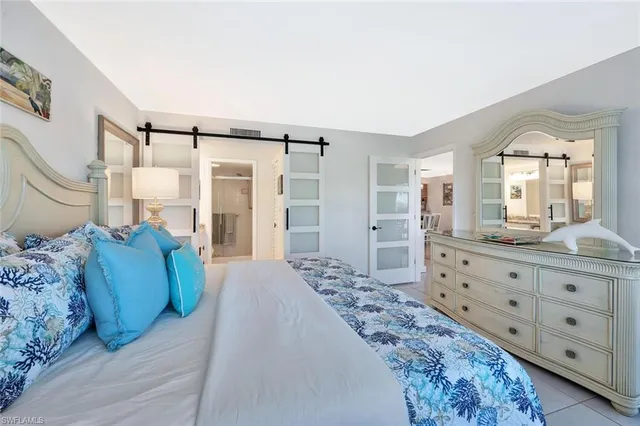 a bedroom with a large bed and a dresser