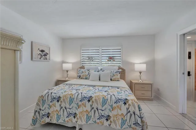 a bedroom with a bed and a night stand