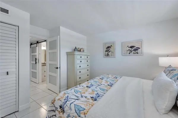 a bedroom with a bed and a view of bathroom