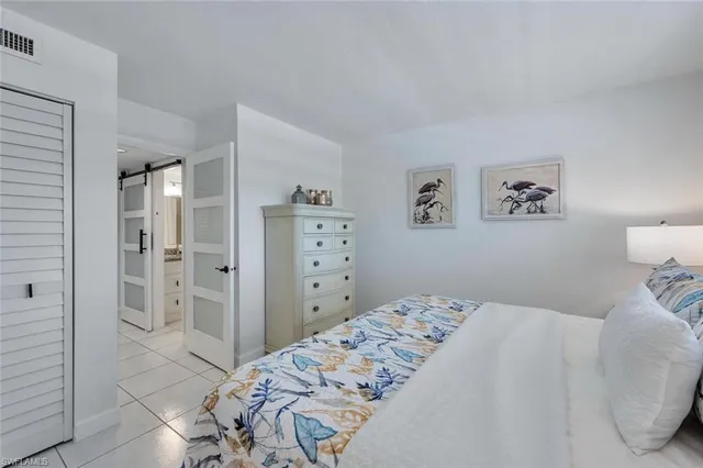 a bedroom with a bed and a view of bathroom