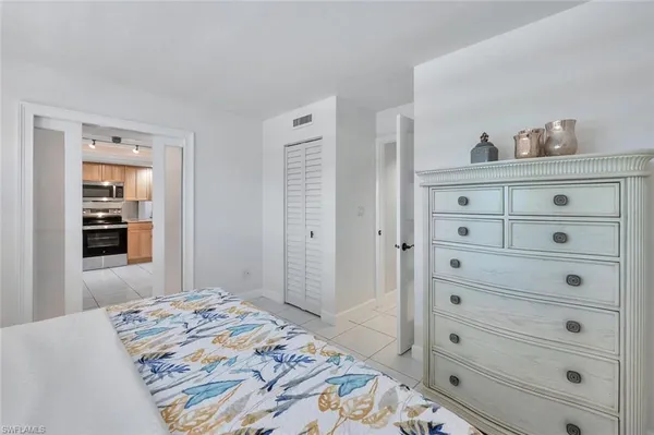 a bedroom with a bed and a dresser