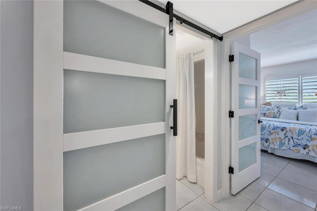 12945 Vanderbilt Drive, Unit 304 Naples, FL 34110 - Photo 32 of 45 a view of room with window and hardwood