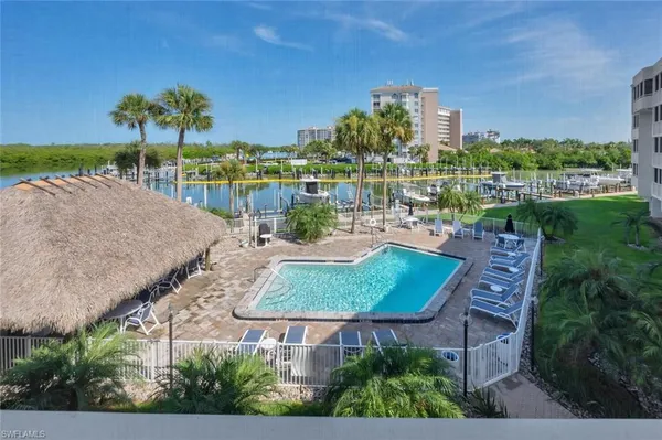 an aerial view of a house with outdoor space and lake view