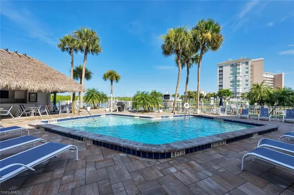 a view of a swimming pool with a table and chairs