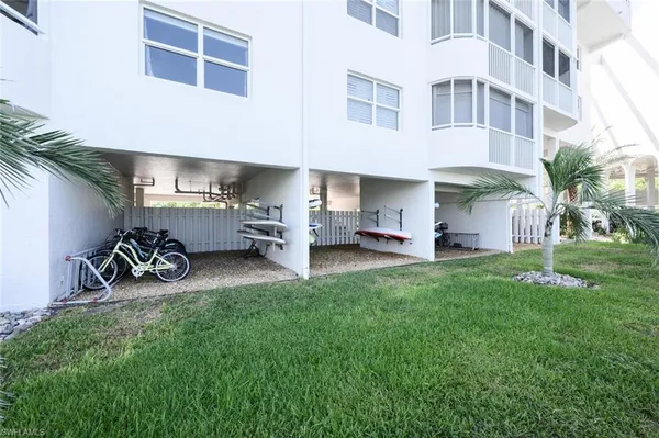 a view of a patio with table and chairs and a barbeque