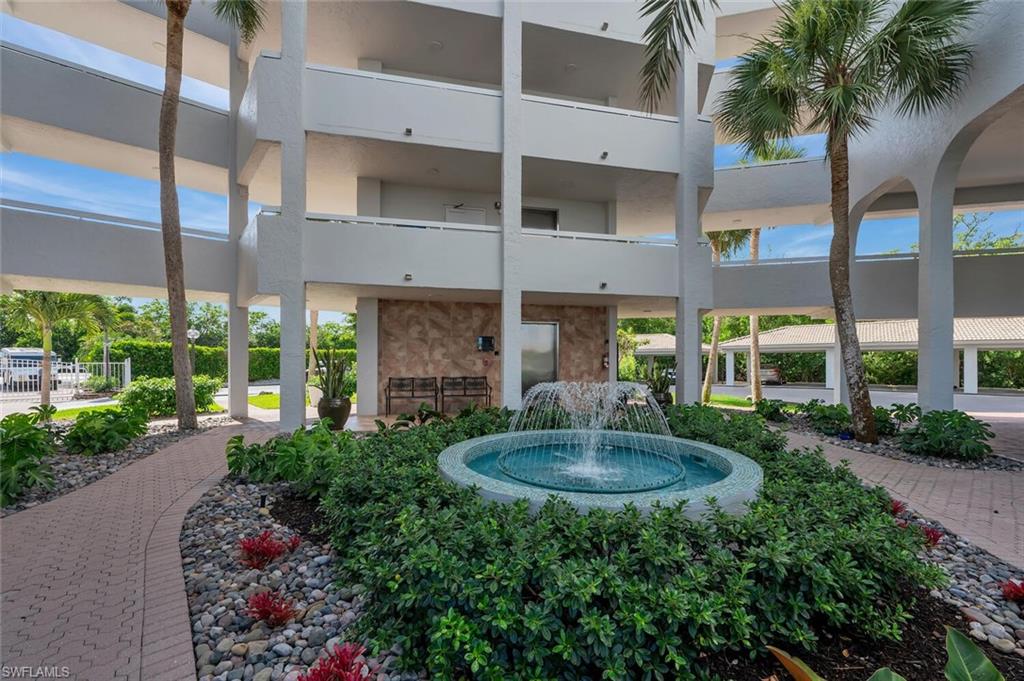 12945 Vanderbilt Drive, Unit 304 Naples, FL 34110 - Photo 4 of 45 a view of a house with a sink and a yard