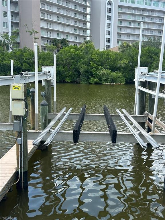 12945 Vanderbilt Drive, Unit 304 Naples, FL 34110 - Photo 43 of 45 a view of a swimming pool with a lake view