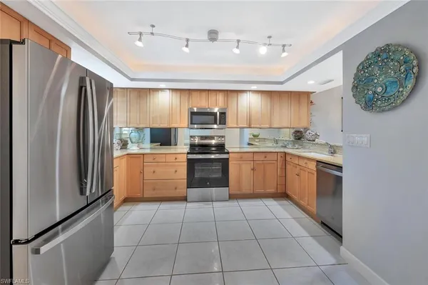 a kitchen with a stove sink and refrigerator
