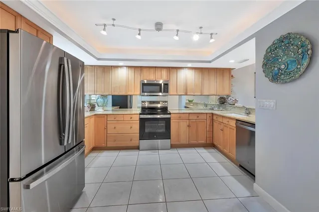 a kitchen with a stove sink and refrigerator