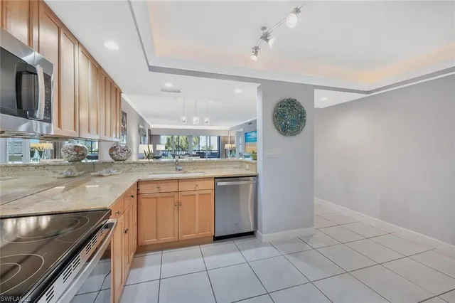 a kitchen with a sink cabinets and stainless steel appliances