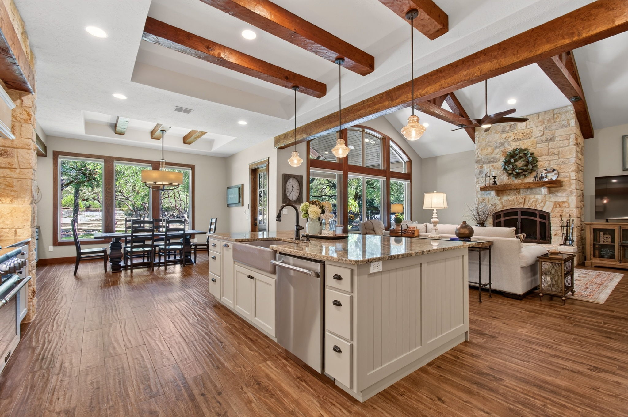 715 Long Ridge Spring Branch, TX 78070 - Photo 19 of 40 Rich wood beams and warm stone accents define this inviting, open-concept culinary space.