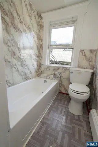 a bathroom with a toilet and a bathtub