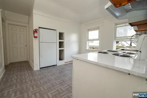 a kitchen with kitchen island a counter top space a sink and appliances