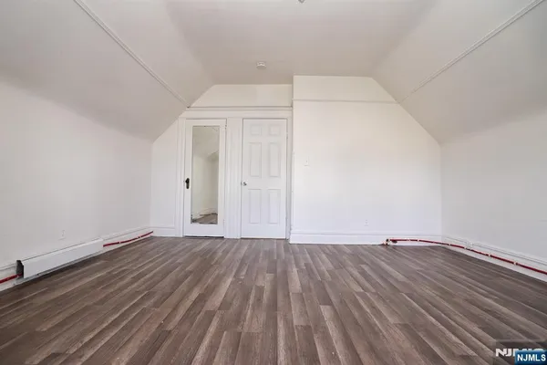 an empty room with wooden floor
