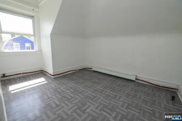 a view of a room with wooden floor and fan