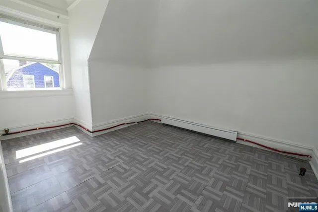a view of a room with wooden floor and fan