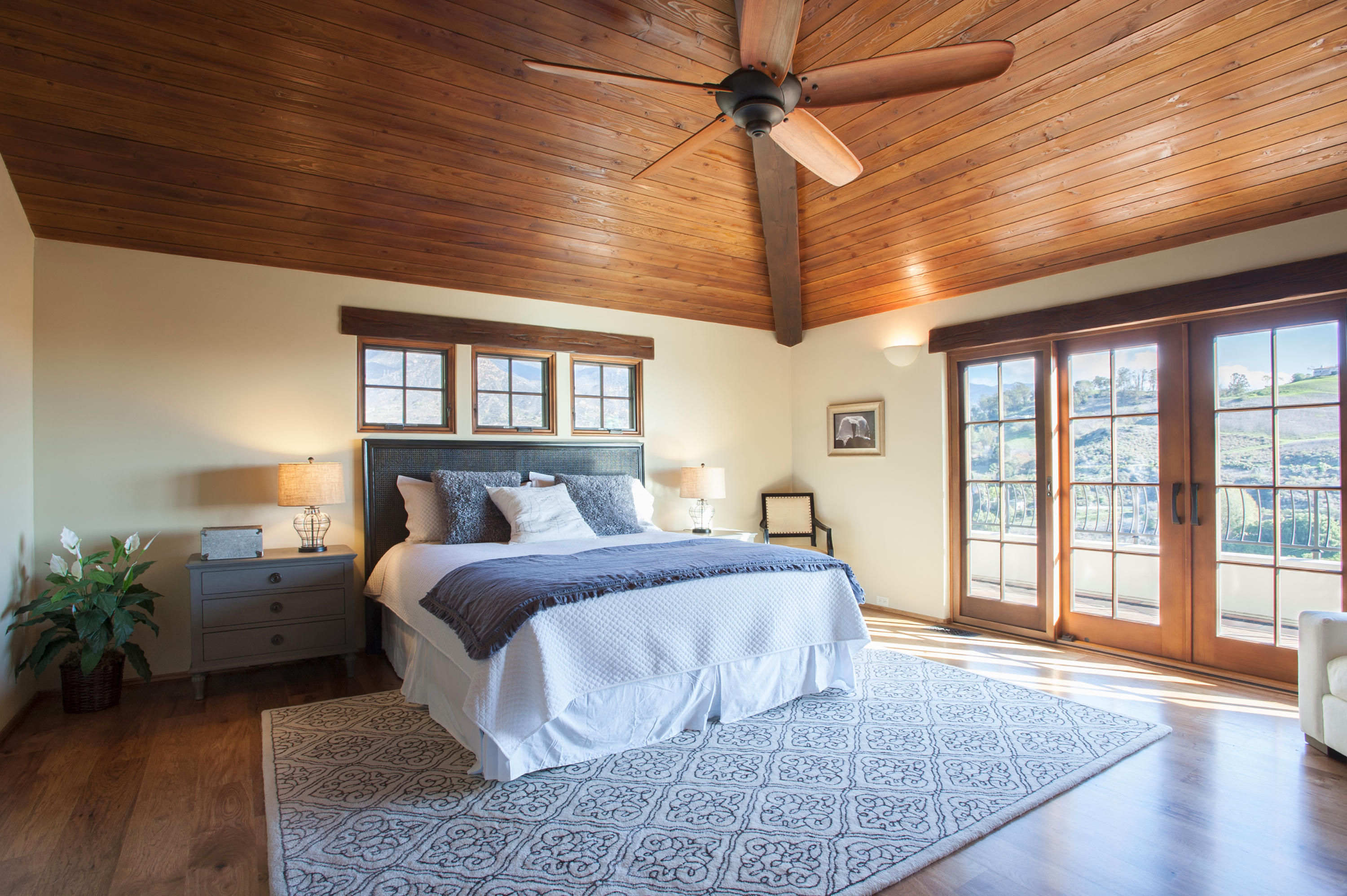 20 Alisal Road Santa Barbara, CA 93103 - Photo 17 of 33 a spacious bedroom with a large bed and a chandelier