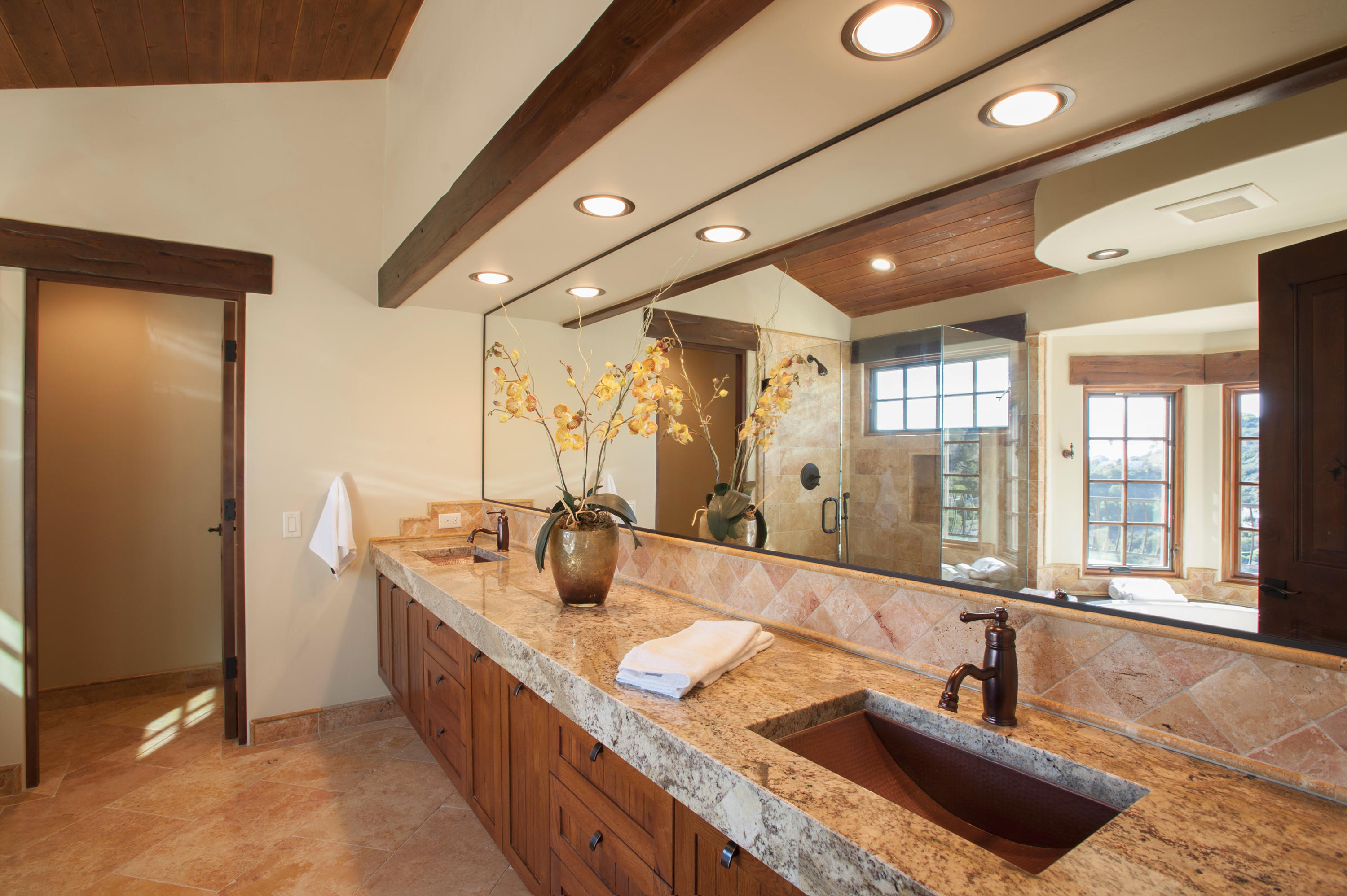20 Alisal Road Santa Barbara, CA 93103 - Photo 19 of 33 a bathroom with a granite countertop sink and a large mirror
