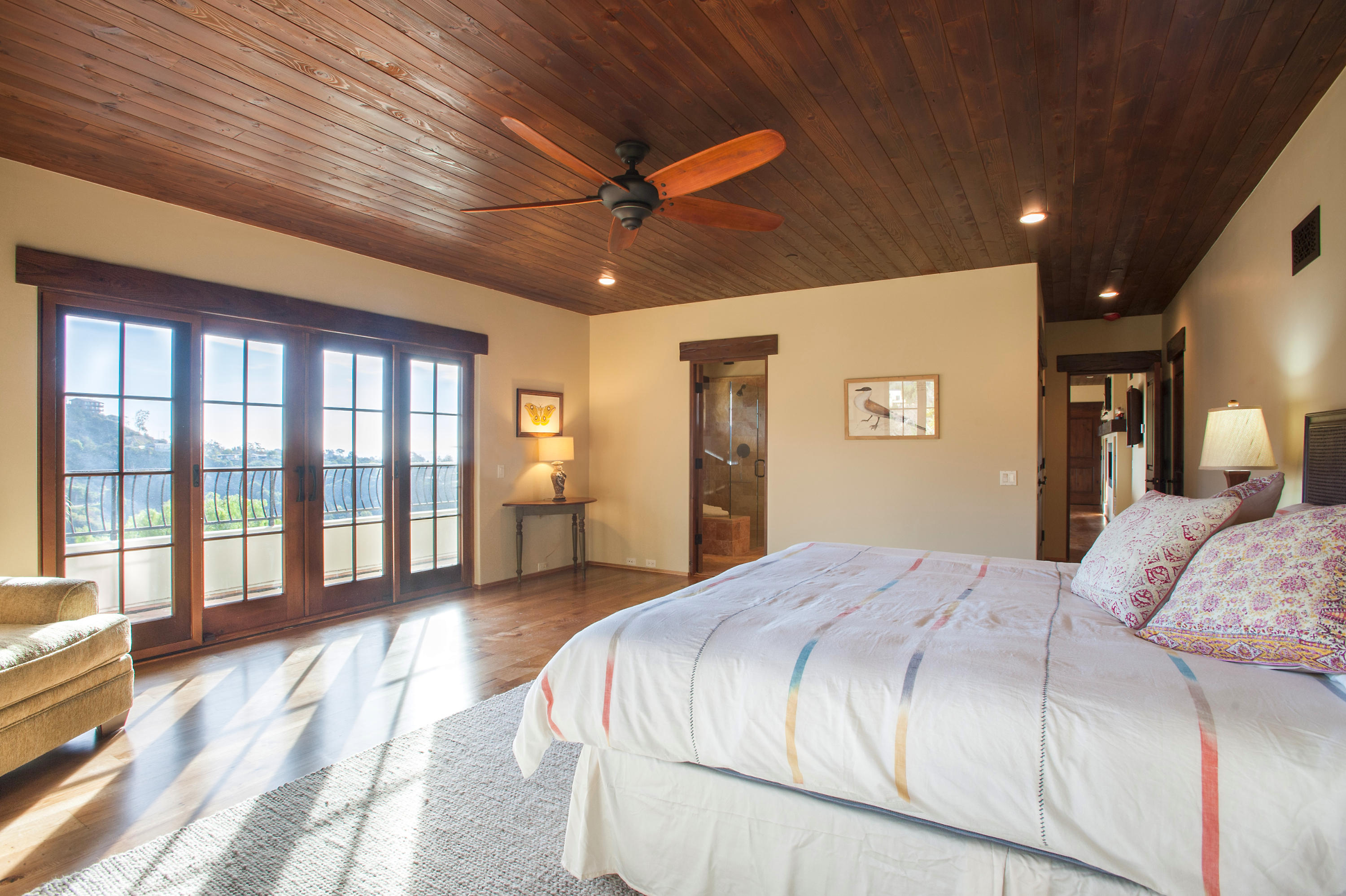 20 Alisal Road Santa Barbara, CA 93103 - Photo 30 of 33 a spacious bedroom with a large bed and a chandelier