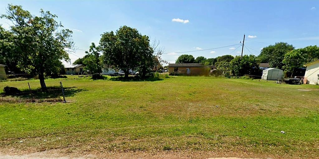 a view of a garden with a building in the background