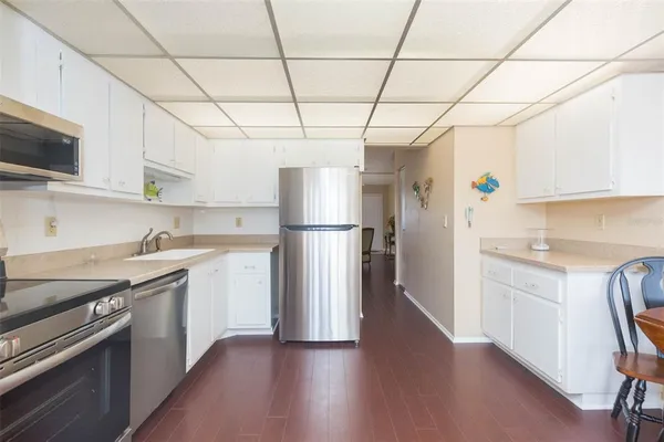 a kitchen with stainless steel appliances granite countertop a refrigerator and a stove top oven