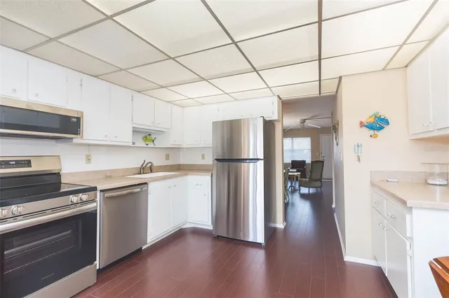 a kitchen with refrigerator and cabinets