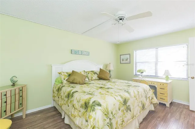 a bed sitting in a spacious bedroom next to a window