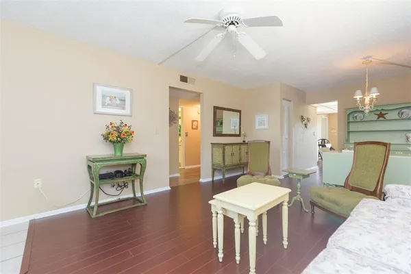 a living room with furniture a fireplace and a chandelier