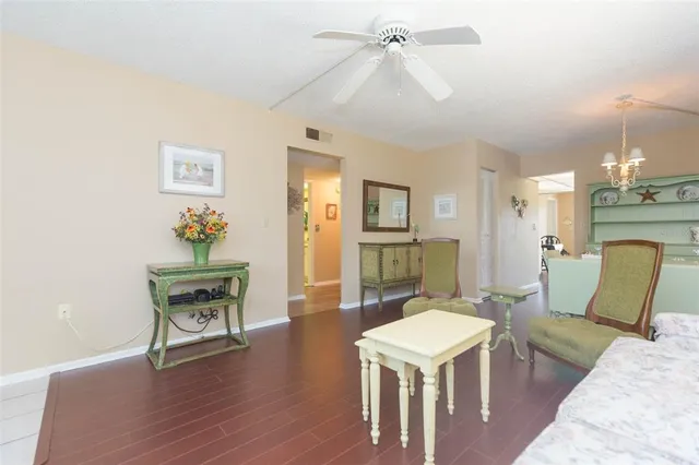 a living room with furniture a fireplace and a chandelier