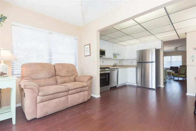 a living room with furniture and a kitchen view