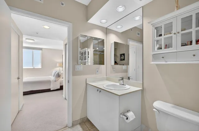 a en suite bathroom with a toilet sink and mirror
