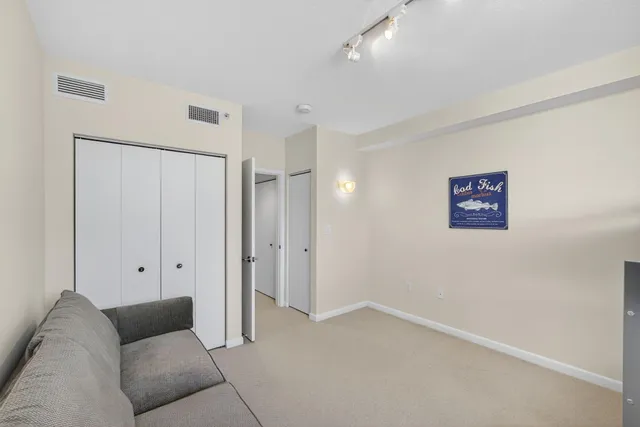 a view of a livingroom with furniture and a ceiling fan