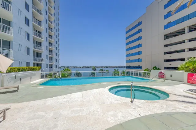 a swimming pool with a yard and outdoor seating