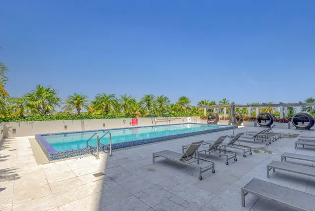 a view of swimming pool with outdoor seating