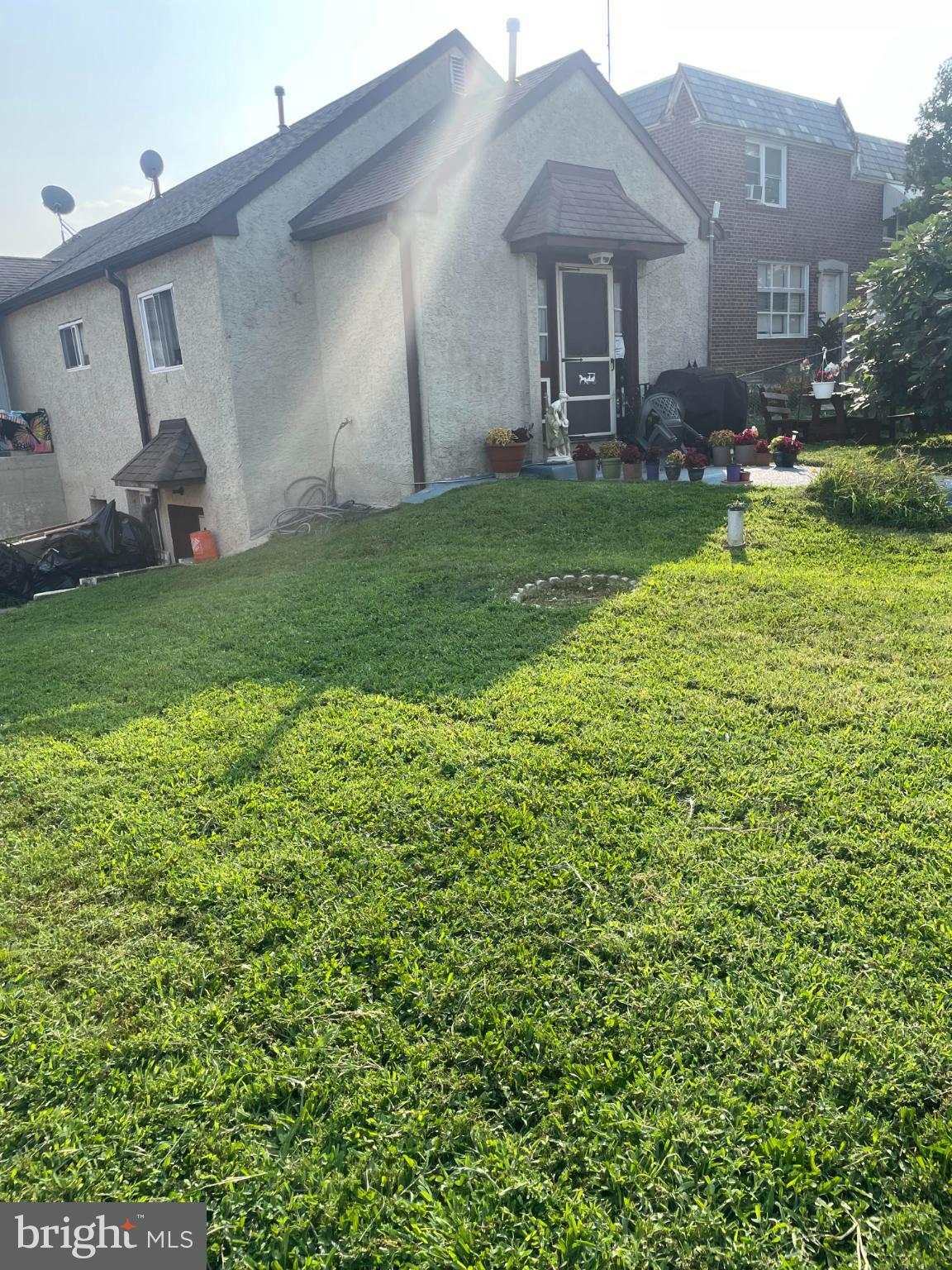 a front view of a house with a garden and yard
