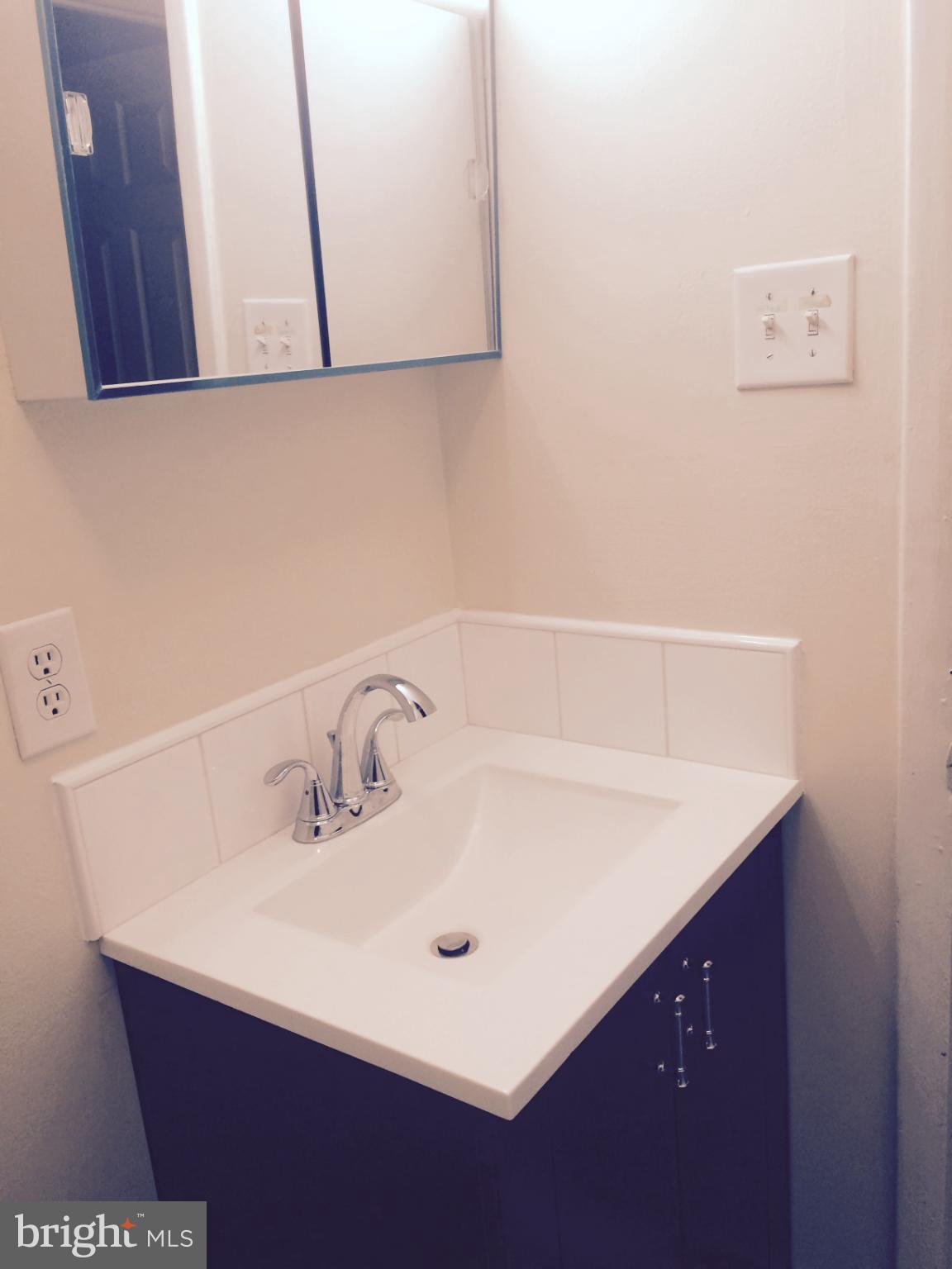 2940 Devereaux Avenue Philadelphia, PA 19149 - Photo 13 of 22 a bathroom with a sink and a mirror