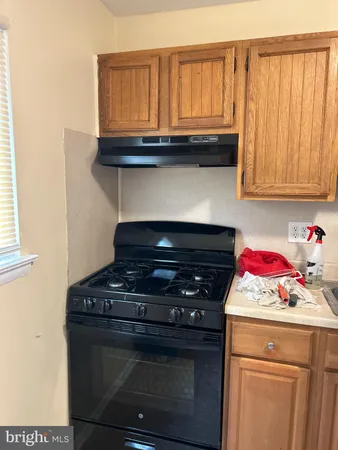 a stove top oven sitting inside of a kitchen