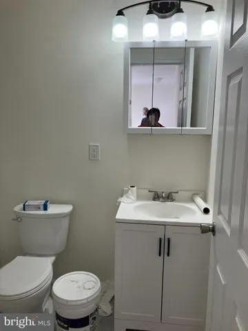 a bathroom with a toilet a sink and mirror