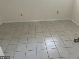 a view of a room with white tiles